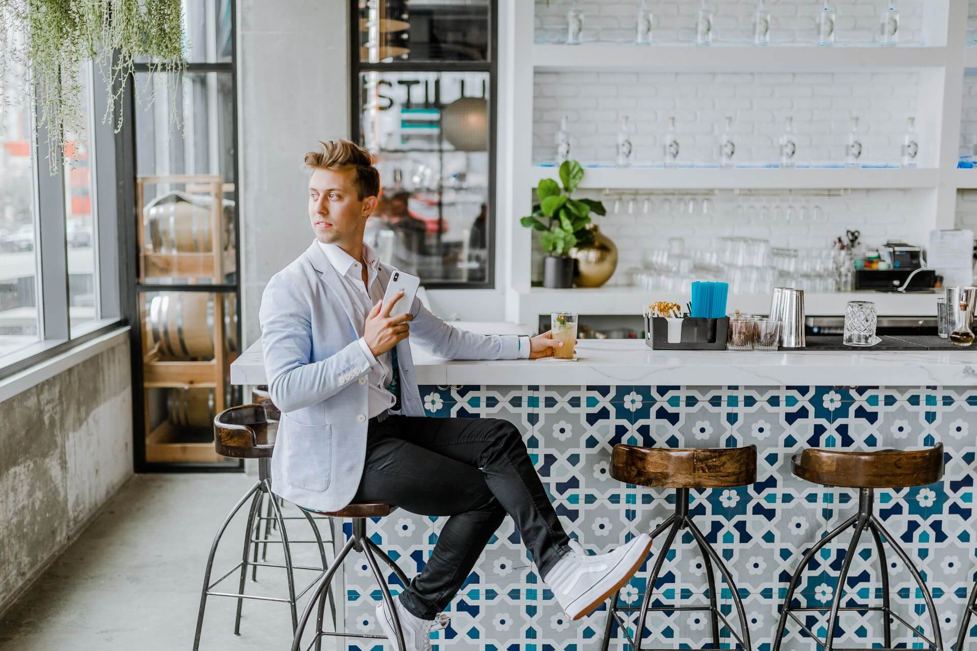 A man sitting alone in a cafe waiting for someone who will never show up.